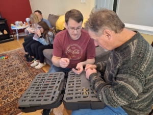 Two people looking at painted miniatures