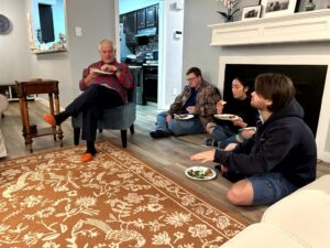 People seated on a floor with food