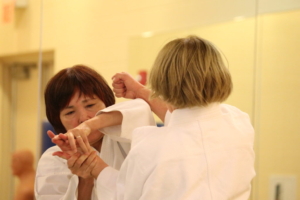 two women working on aikido
