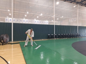 Rich cleaning the mats after practice