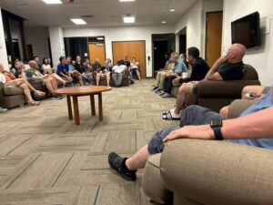 people in a ring of chairs