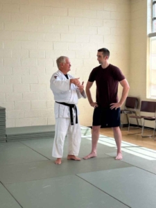 Two martial artists discussing technique