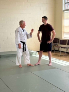 Two martial artists discussing technique