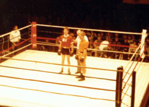 two fighters and a referree boxing ring