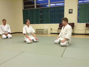 two people kneeling on mats